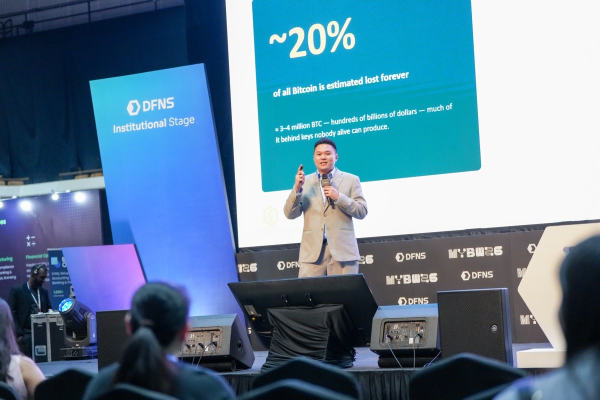 Tan Ji Sheng keynoting on the DFNS Institutional Stage at Malaysia Blockchain Week 2026 — slide: ~20% of all Bitcoin is estimated lost forever